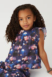 GS0017 Navy Smithsonian Planet Print Ruffled Tank Pose